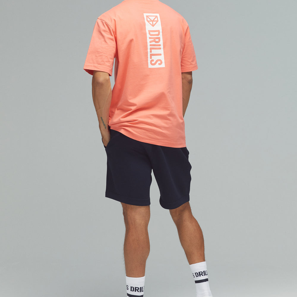 
                      
                        RECREATION DRILLS Vertical Graphic Tee Sunset Glow/White
                      
                    