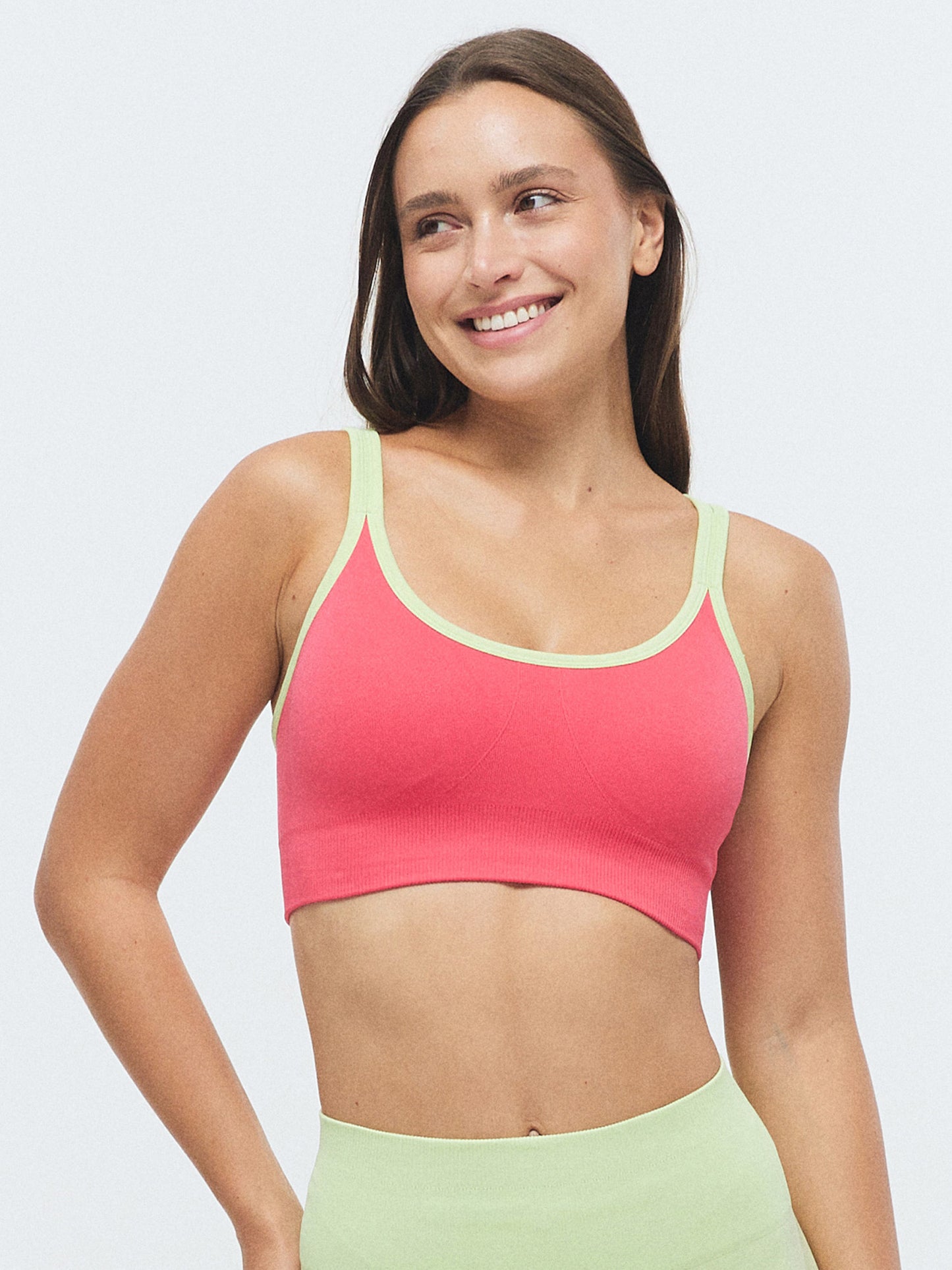 Model trägt den VIVID Duo Sport BH von DRILLS in der Farbe Raspberry